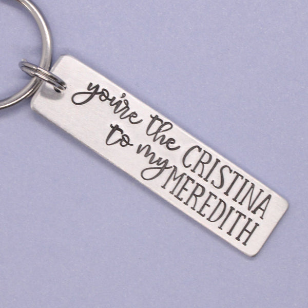 Keychain with engraved You're the Cristina to my Meredith on a light purple background
