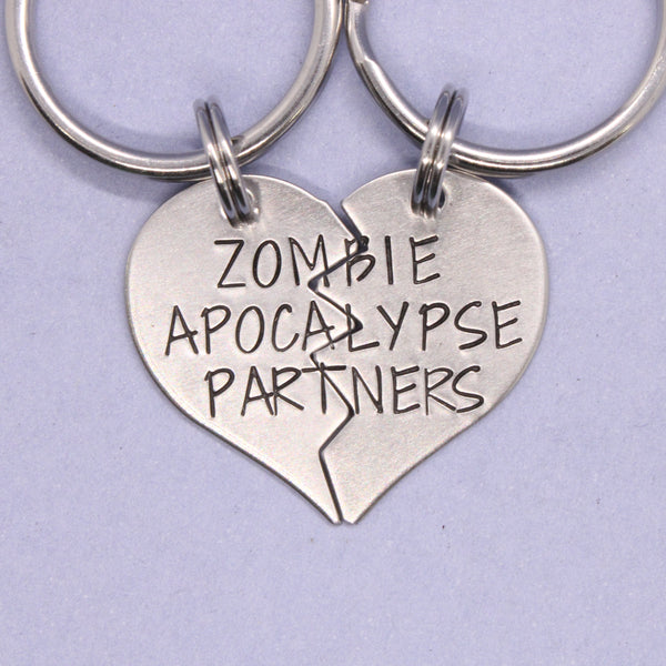 Heart-shaped keychain with 'Zombie Apocalypse Partners' text on a light purple background