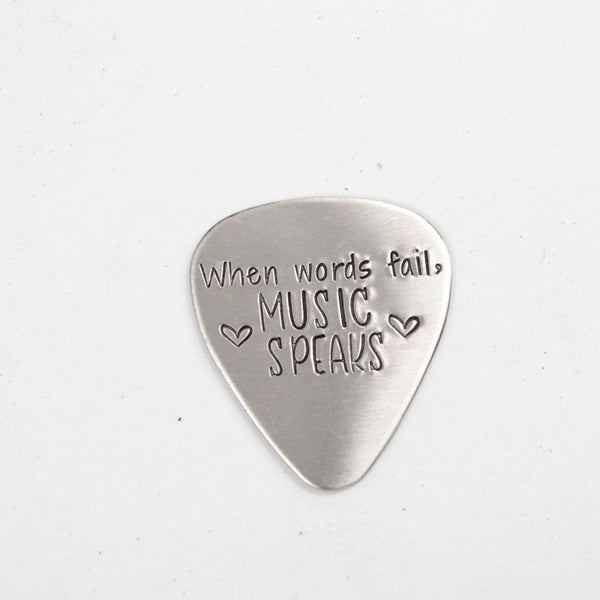 "When words fail, music speaks" Guitar Pick - Available in stainless steel, brass, and copper
