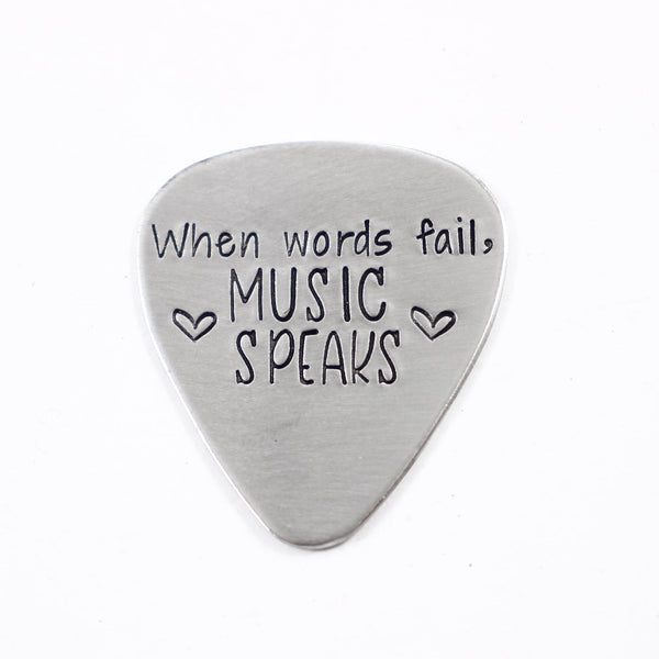 "When words fail, music speaks" Guitar Pick - Available in stainless steel, brass, and copper