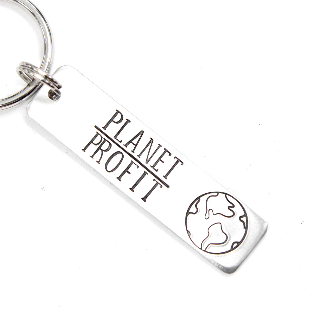 "Planet over profit" Keychain - Handstamped - available in Aluminum or Stainless Steel - option to personalize the back